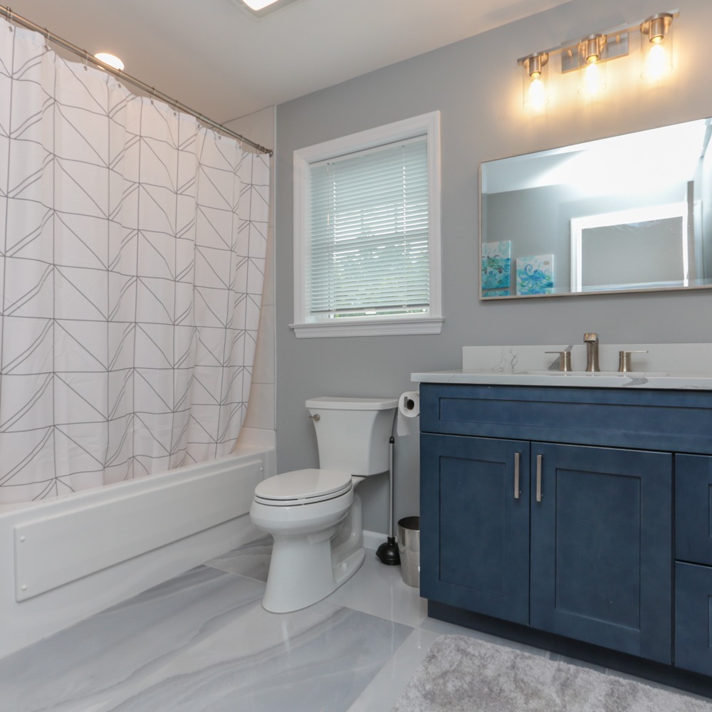 Bathroom renovation with frameless glass and tile