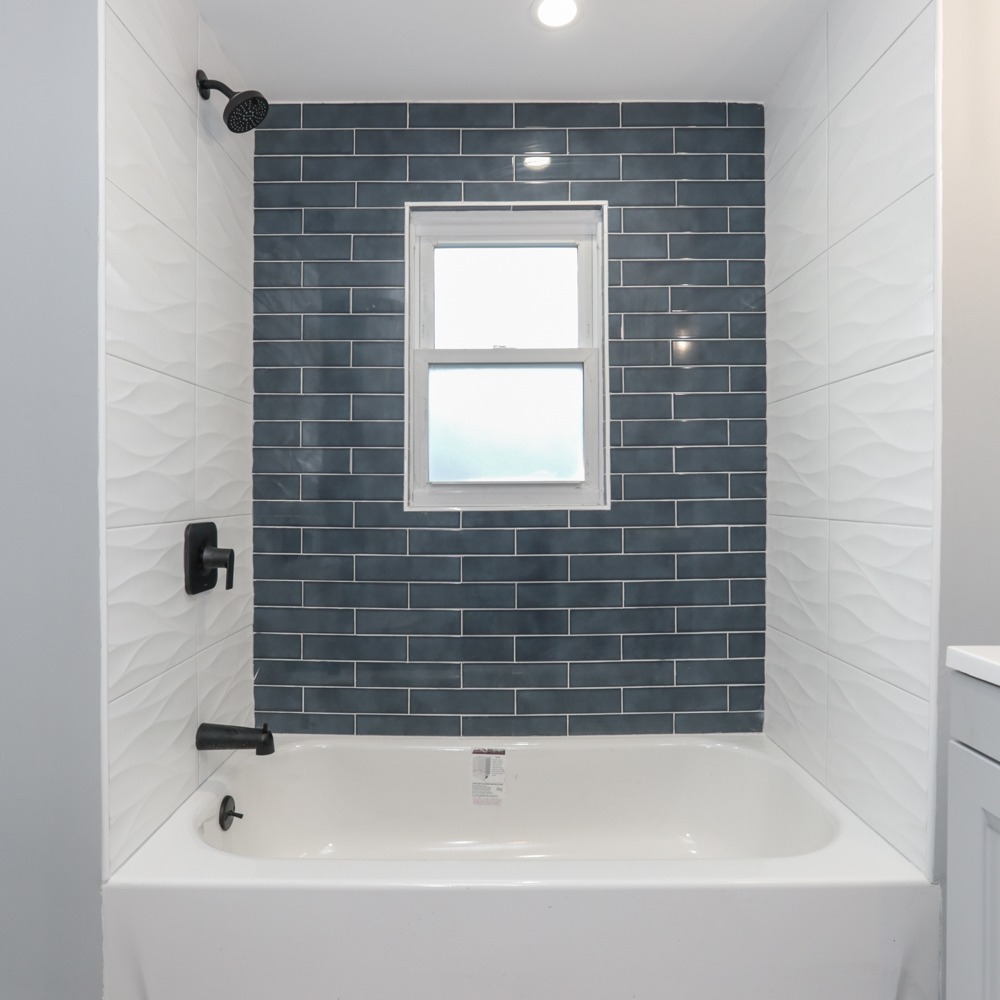 Bathroom renovation with geometric tile pattern